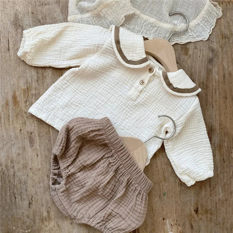 Organic Cotton Baby Boy Outfit Navy Shirt & Bloomers 2pcs Set in soft cream and brown colors on wooden background