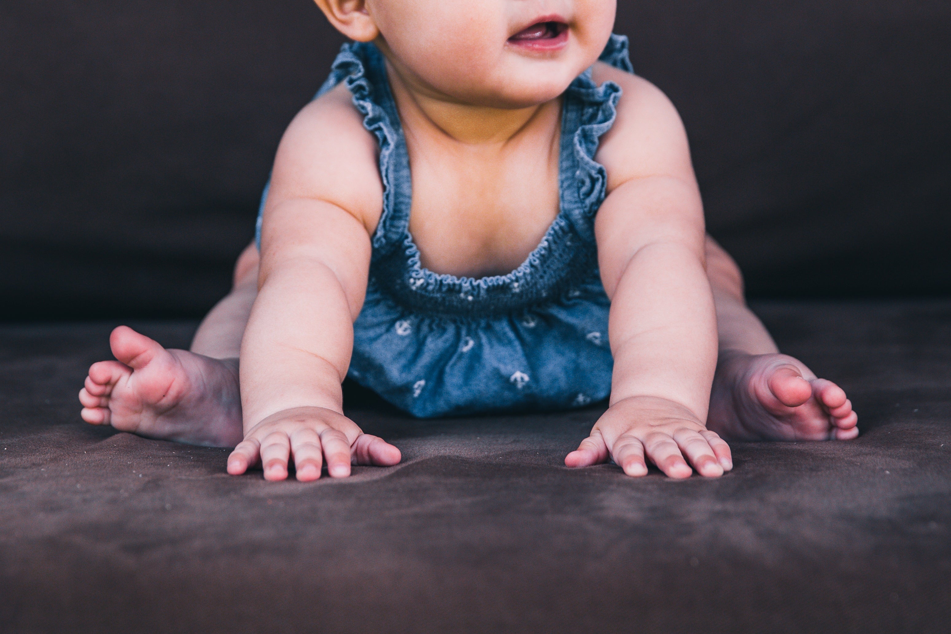 Baby girl wearing blue outfit crawling on a dark surface Girls Clothing & Accessories for Every Little Personality