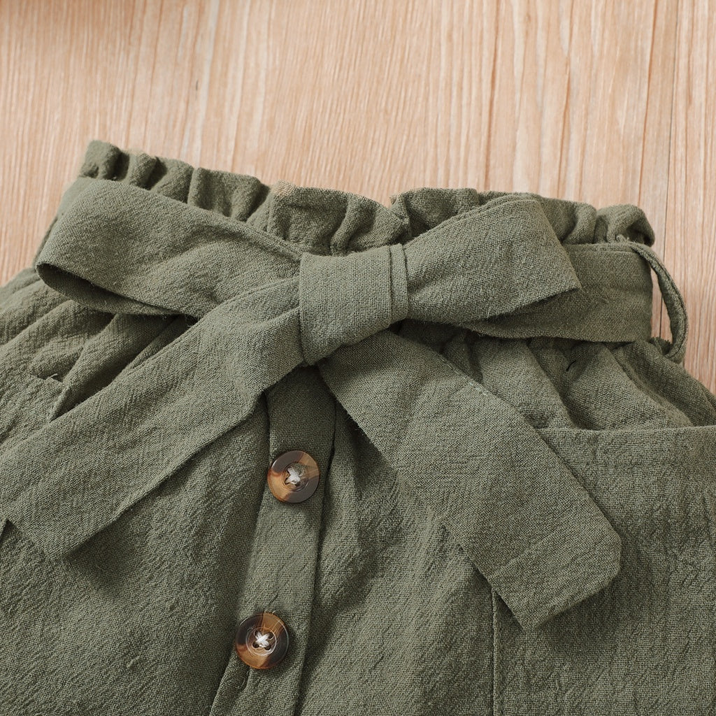 Close-up of olive green fabric with buttons and a tied bow detail from 2PCS Baby Girl Clothing Set by Yamza Tots Closet