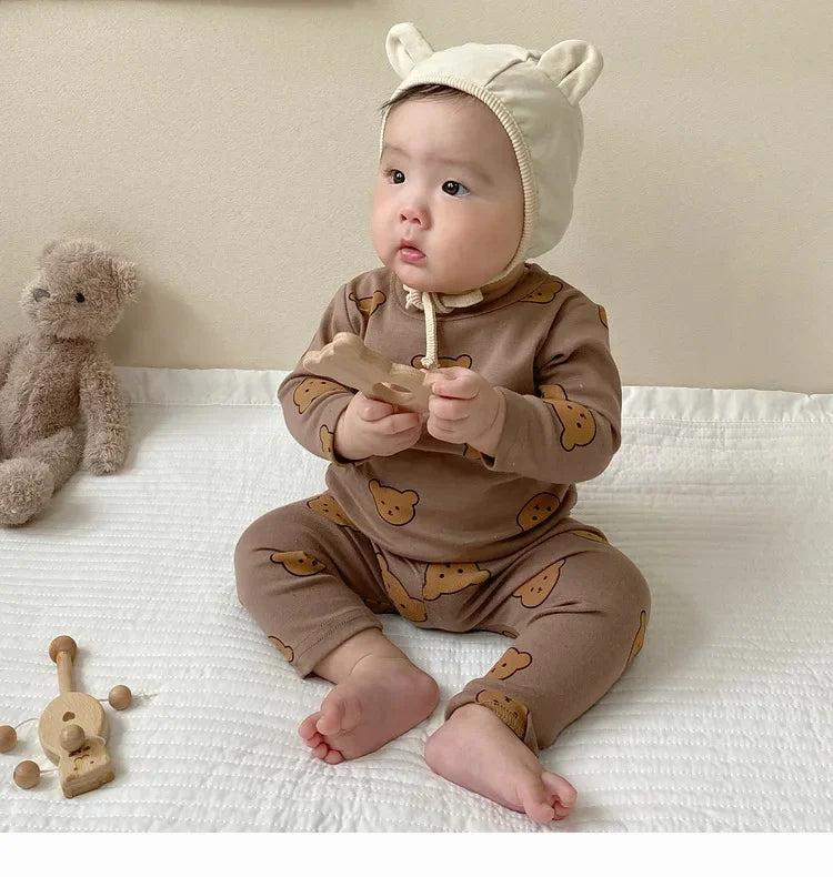 Baby wearing Baby 2PCS Pajama Set Cotton Long Sleeve Outfit for Autumn Winter Wear with bear print and beige hat with ears