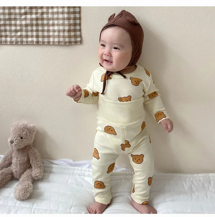 Baby wearing Baby 2PCS Pajama Set Cotton Long Sleeve Outfit for Autumn Winter Wear with bear prints and brown bonnet