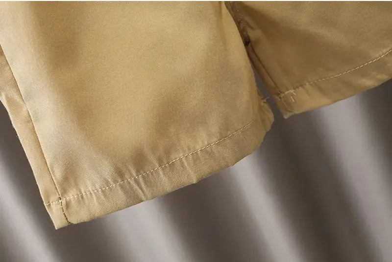 Close-up of tan fabric details from baby boy clothes set by Yamza Tots' Closet