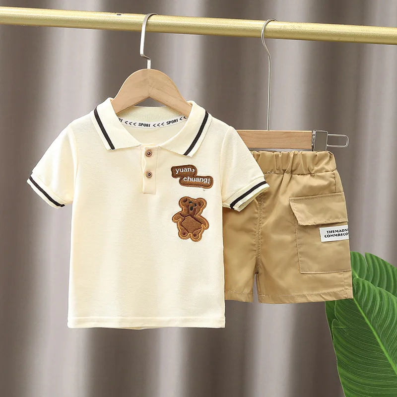 Baby Boy Clothes Set with cream polo shirt and khaki shorts featuring bear patch from Yamza Tots' Closet