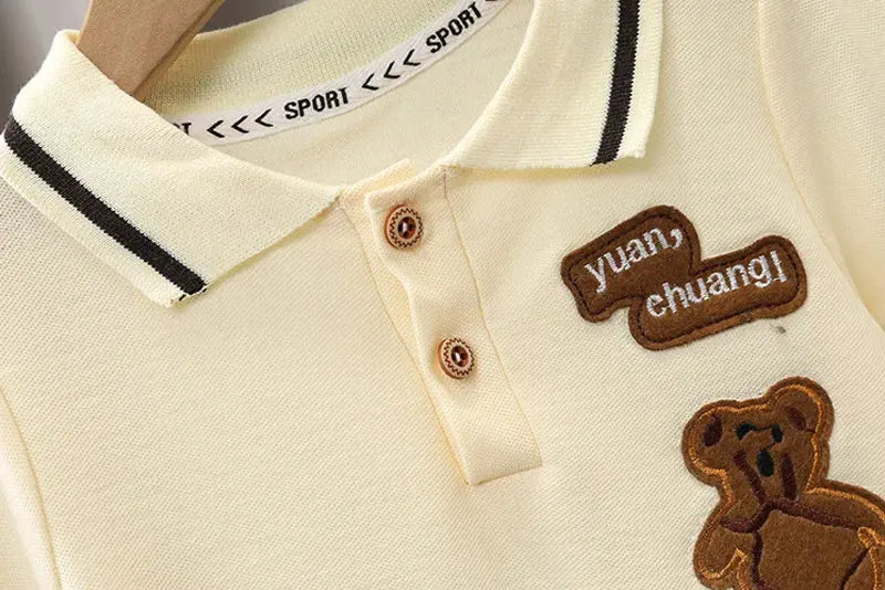 Close-up of baby boy clothes set polo shirt with sport collar and teddy bear patch by Yamza Tots' Closet