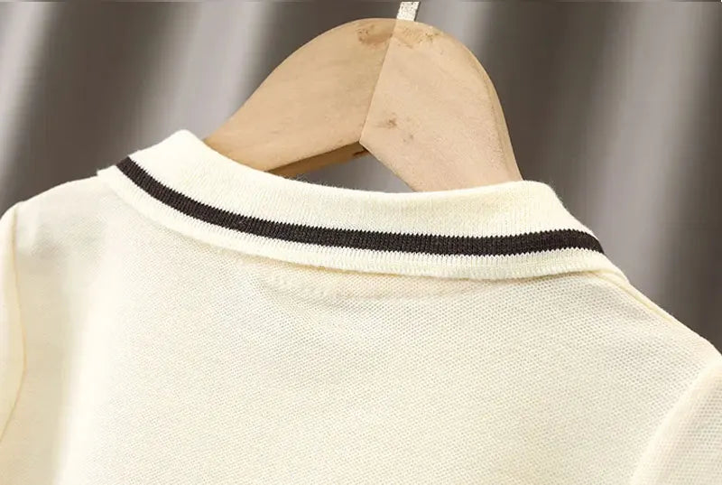 Close-up of cream collar with black stripe on baby boy clothes set by Yamza Tots' Closet