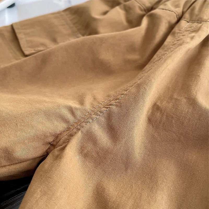 Close-up of brown fabric stitching on baby boys striped clothing suits from Yamza Tots' Closet