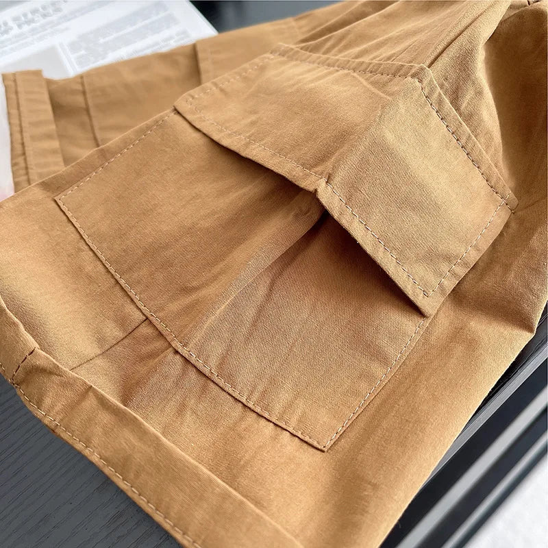 Close-up of brown fabric pocket detail on baby clothing from Yamza Tots Closet baby boys striped clothing suits