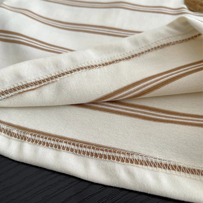 Close-up of soft beige and brown striped fabric for baby boys striped clothing suits by Yamza Tots' Closet
