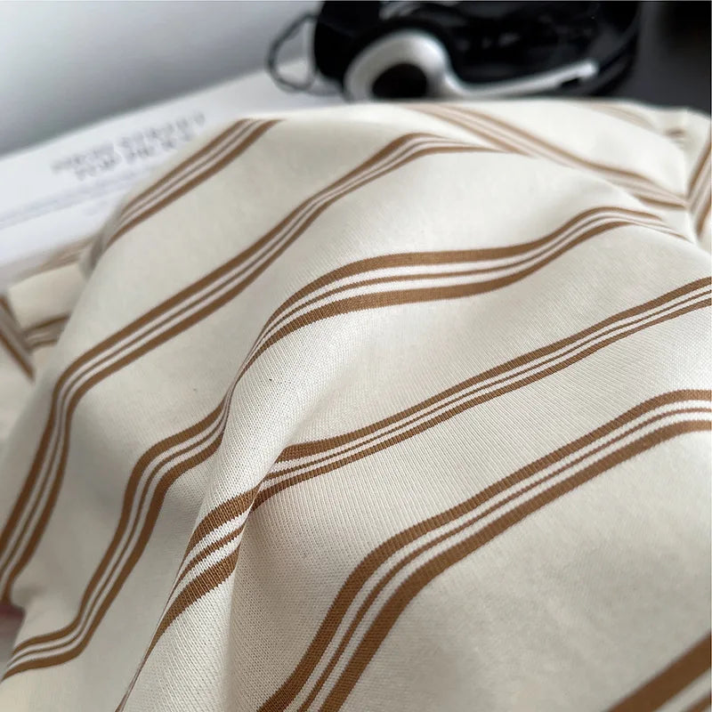 Close-up of soft fabric with brown and white stripes from Baby Boys Striped Clothing Suits by Yamza Tots' Closet
