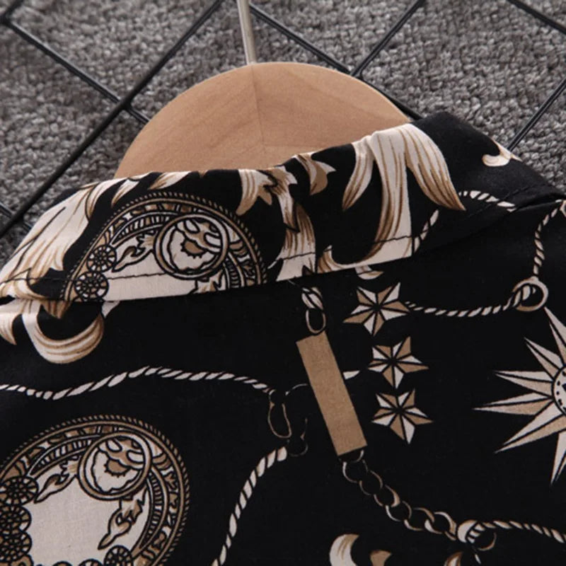 Close-up of Baby Boy's Suit Fashion Print Clothes with intricate black and beige pattern on a hanger