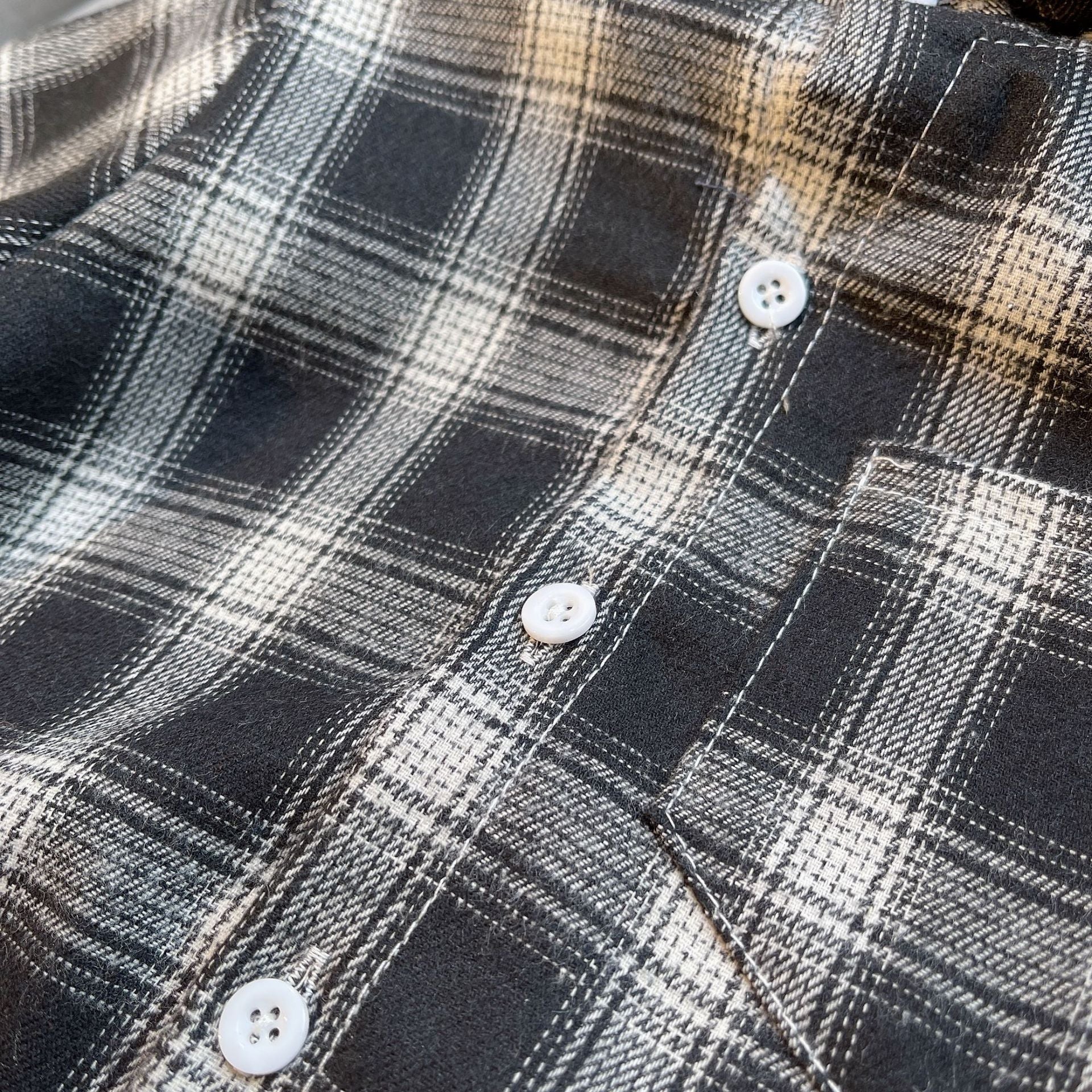 Close-up of black and white plaid shirt buttons from Baby Boys Summer Plaid Outfit Cozy Striped Shirts Tees and Shorts Set