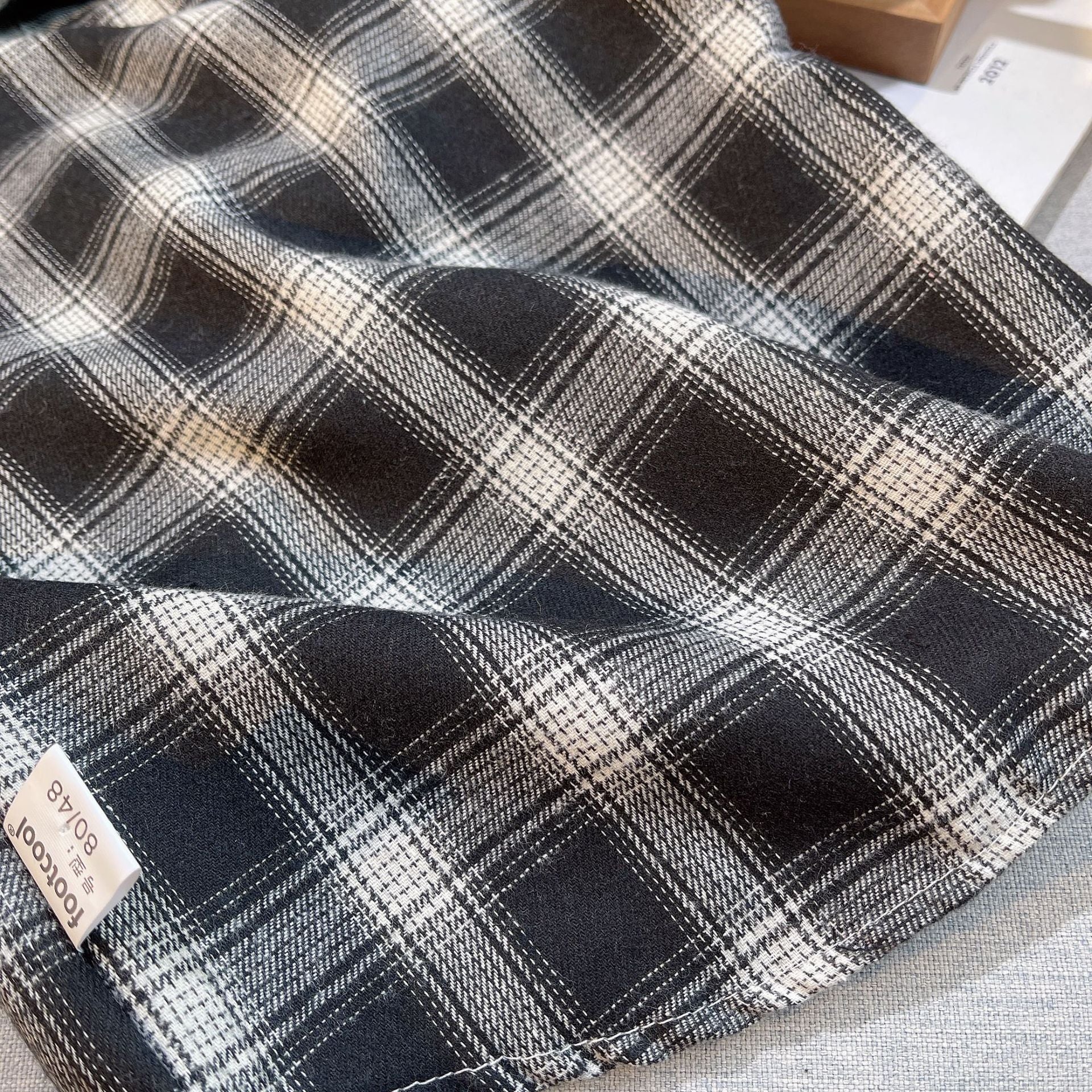Close-up of black and white plaid fabric from Baby Boys Summer Plaid Outfit Cozy Striped Shirts Tees and Shorts Set  