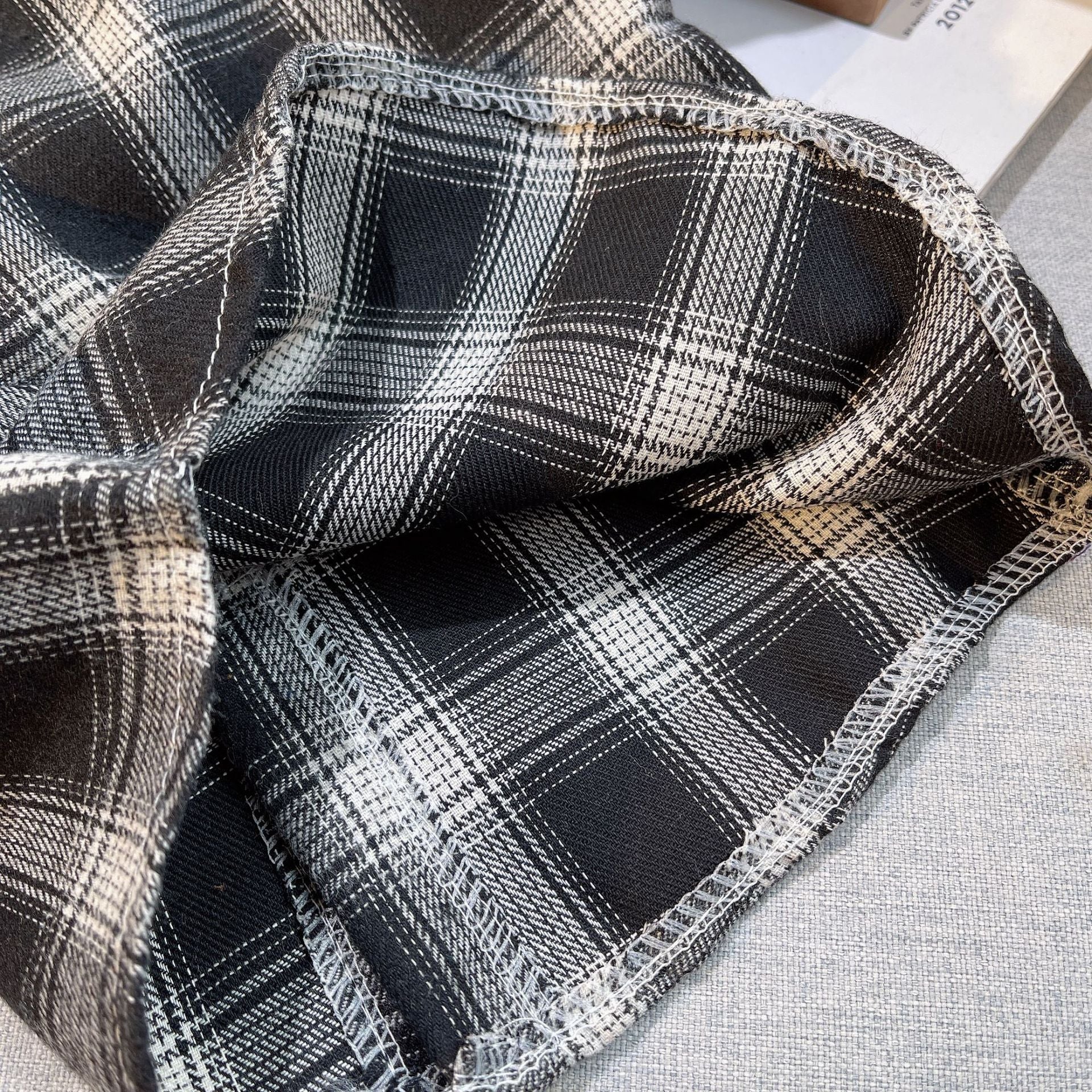 Close-up of black and white plaid fabric for Baby Boys Summer Plaid Outfit Cozy Striped Shirts Tees and Shorts Set