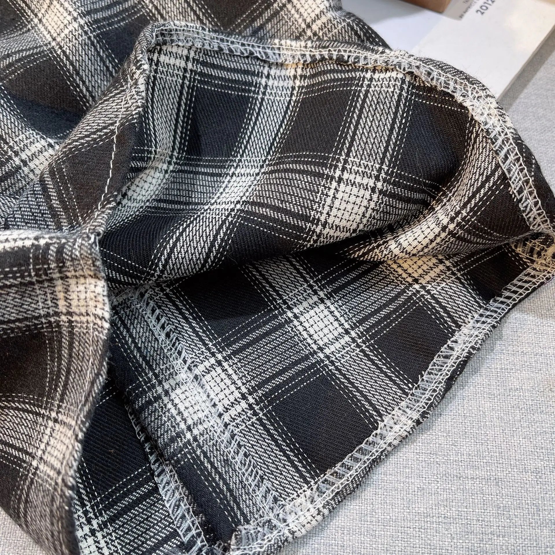 Close-up of black and white plaid fabric for Baby Boys Summer Plaid Outfit Cozy Striped Shirts Tees and Shorts Set  