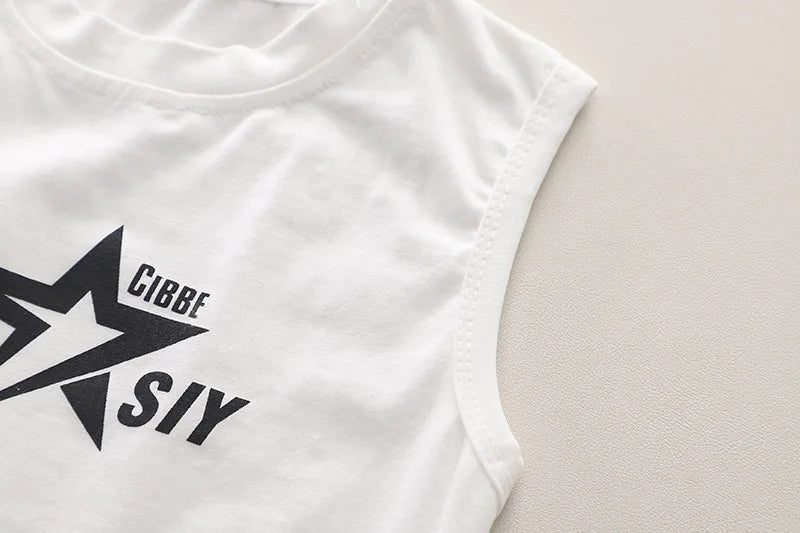 Close-up of white sleeveless baby boys shirt with black star design from Baby Boys Summer Set Striped Shirts Tees and Shorts