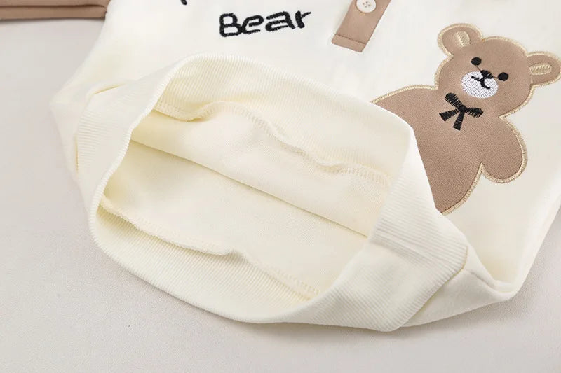 Close-up of cream-colored baby clothes children set boys t-shirt pants 2pcs sets with teddy bear design
