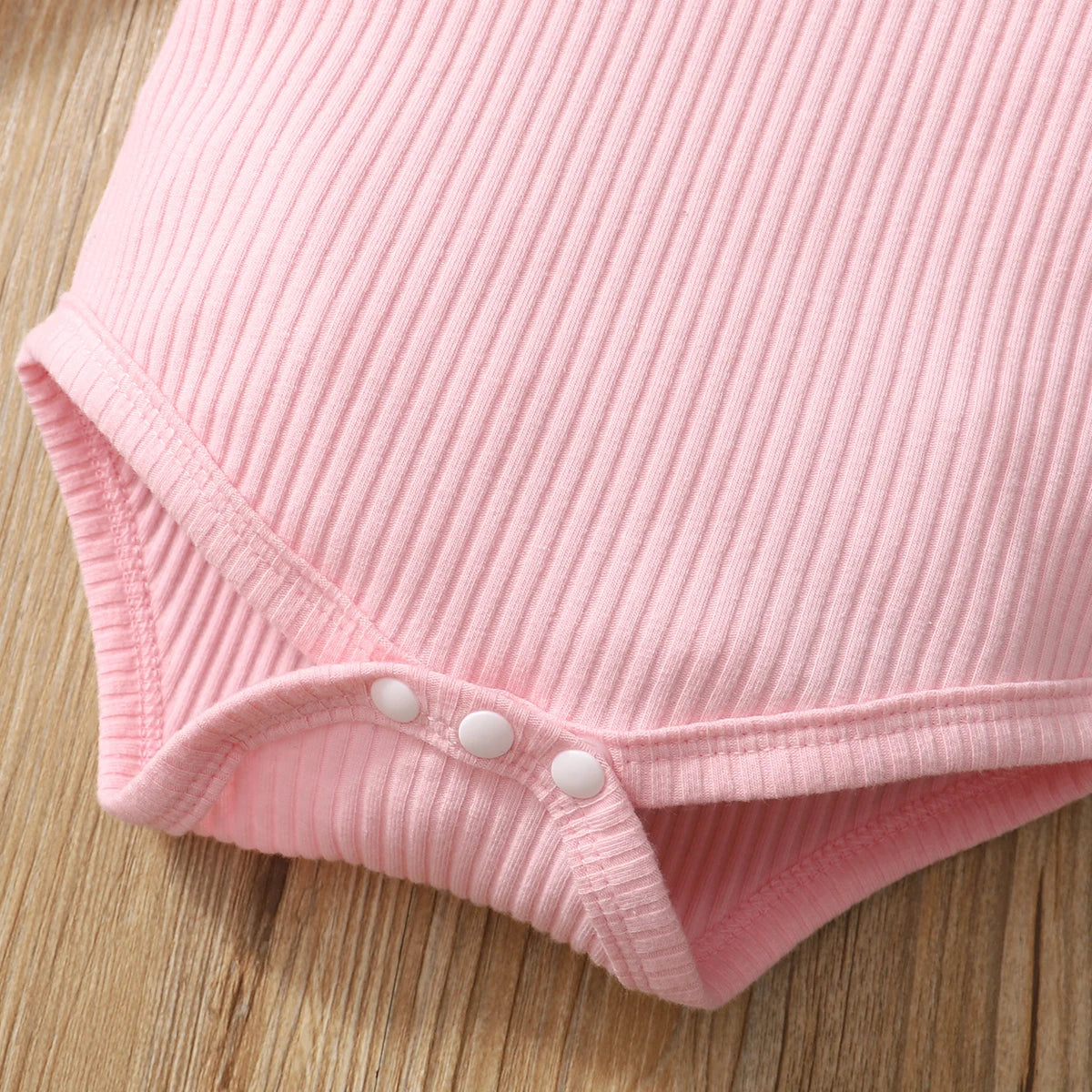 Close-up of pink ribbed fabric on Baby Girl Camouflage Outfit Set with Long Sleeve Bodysuit and Headband