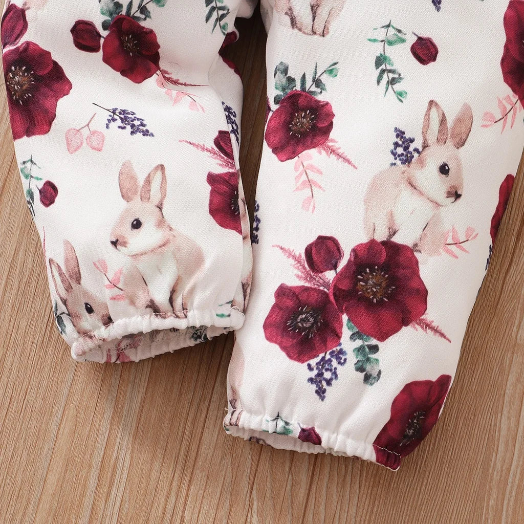 Close-up of baby girl clothes set red color 2PCS featuring floral and bunny print on soft fabric