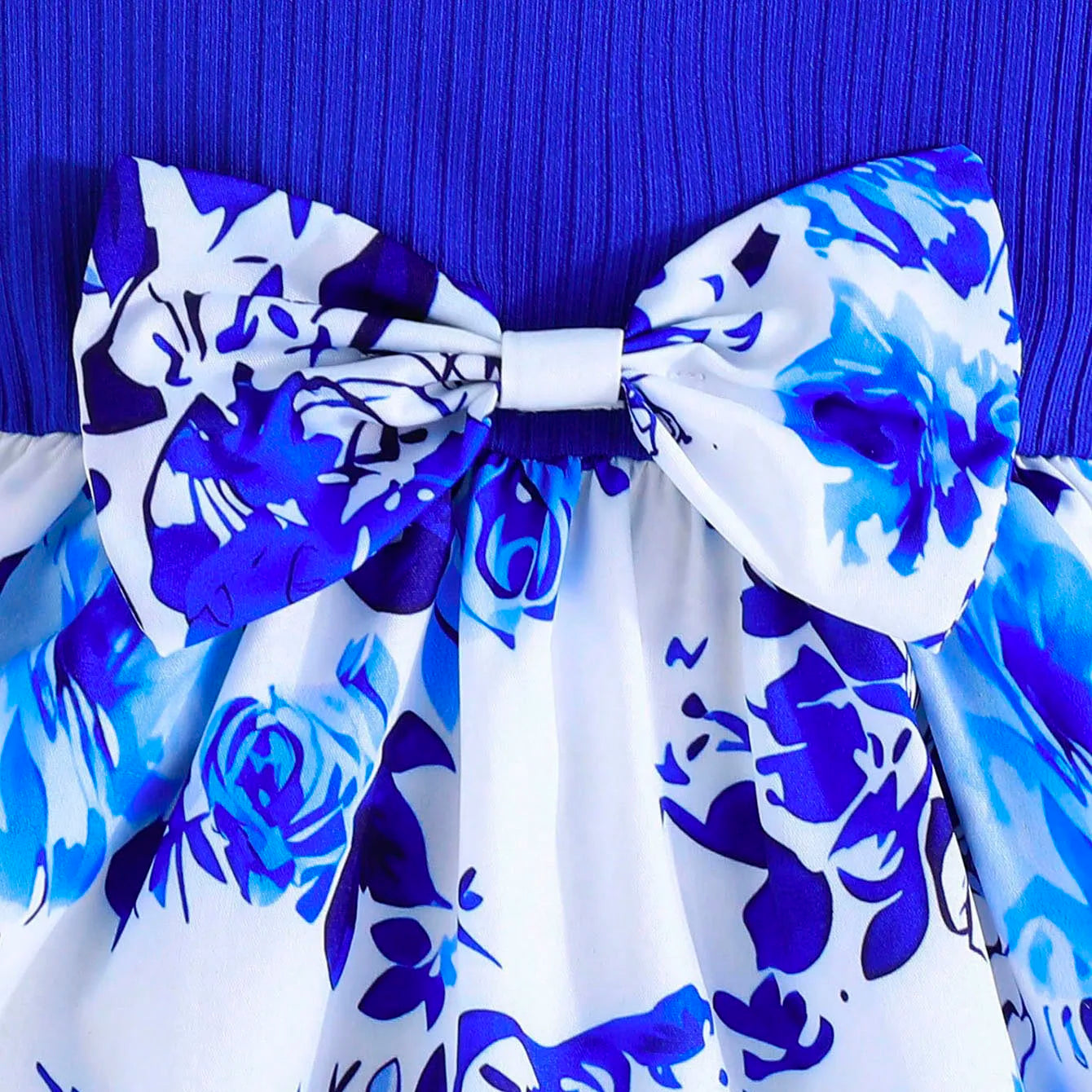 Close-up of blue and white floral Baby Girl Dress Small Flying Sleeve with a large bow detail