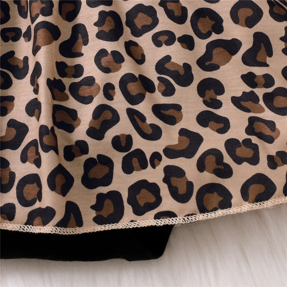 Close-up of leopard print fabric detail on Baby Girl Dress with Bow from Yamza Tots' Closet