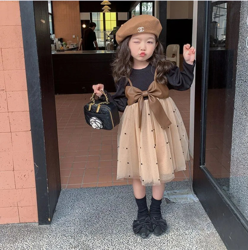 Baby girl wearing Baby Girl Long Sleeve Dress with Big Bow and Tulle Elegant Fashion Outfit with black top and beige skirt