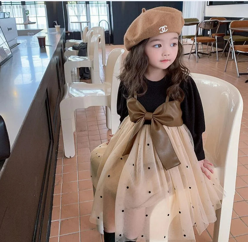 Baby girl wearing Baby Girl Long Sleeve Dress with Big Bow and Tulle Elegant Fashion Outfit sitting on a white chair indoors