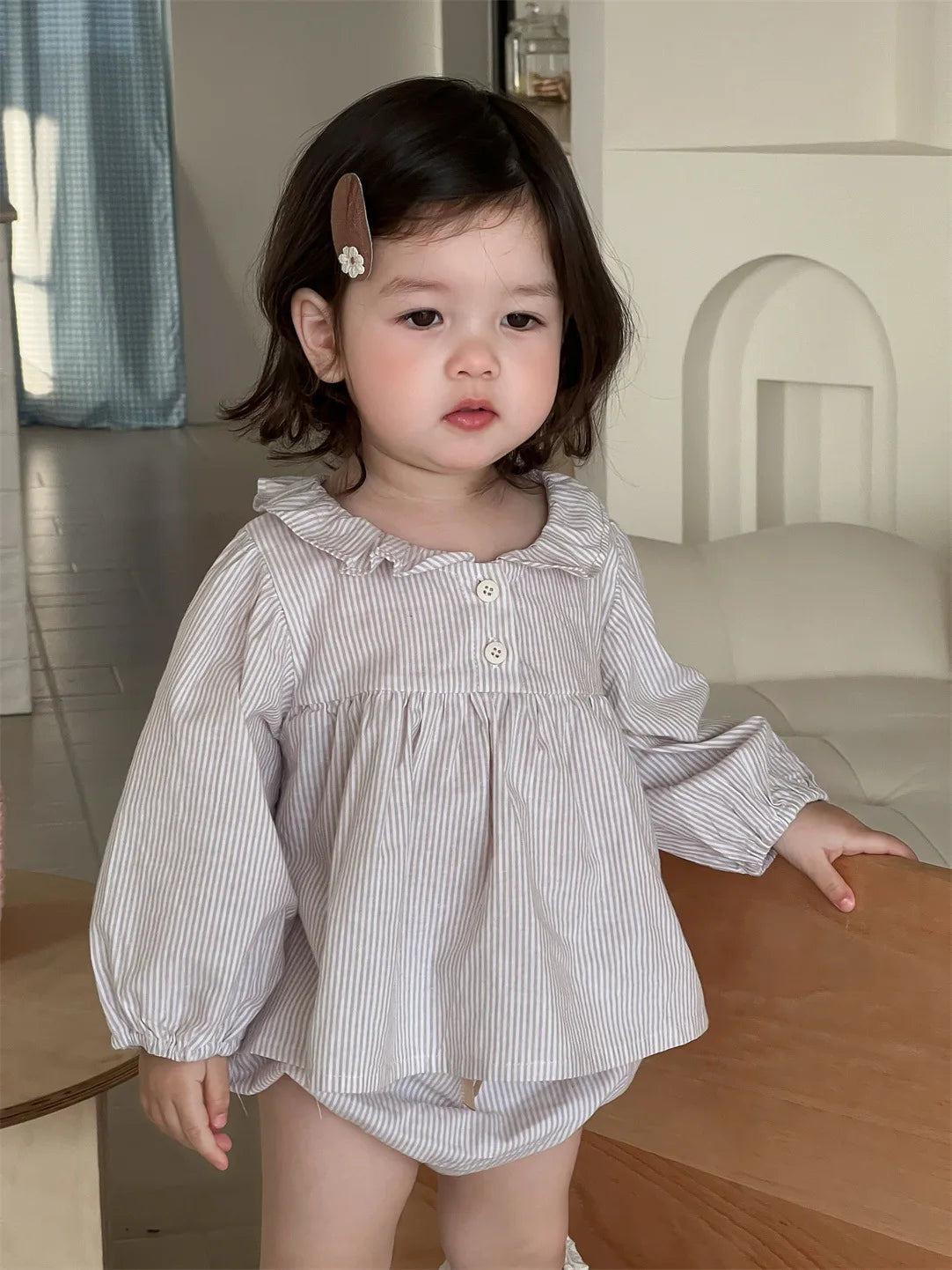 Baby girl wearing Yamza Tots' Closet Baby Girl Loose Striped Set with long sleeves and ruffled collar