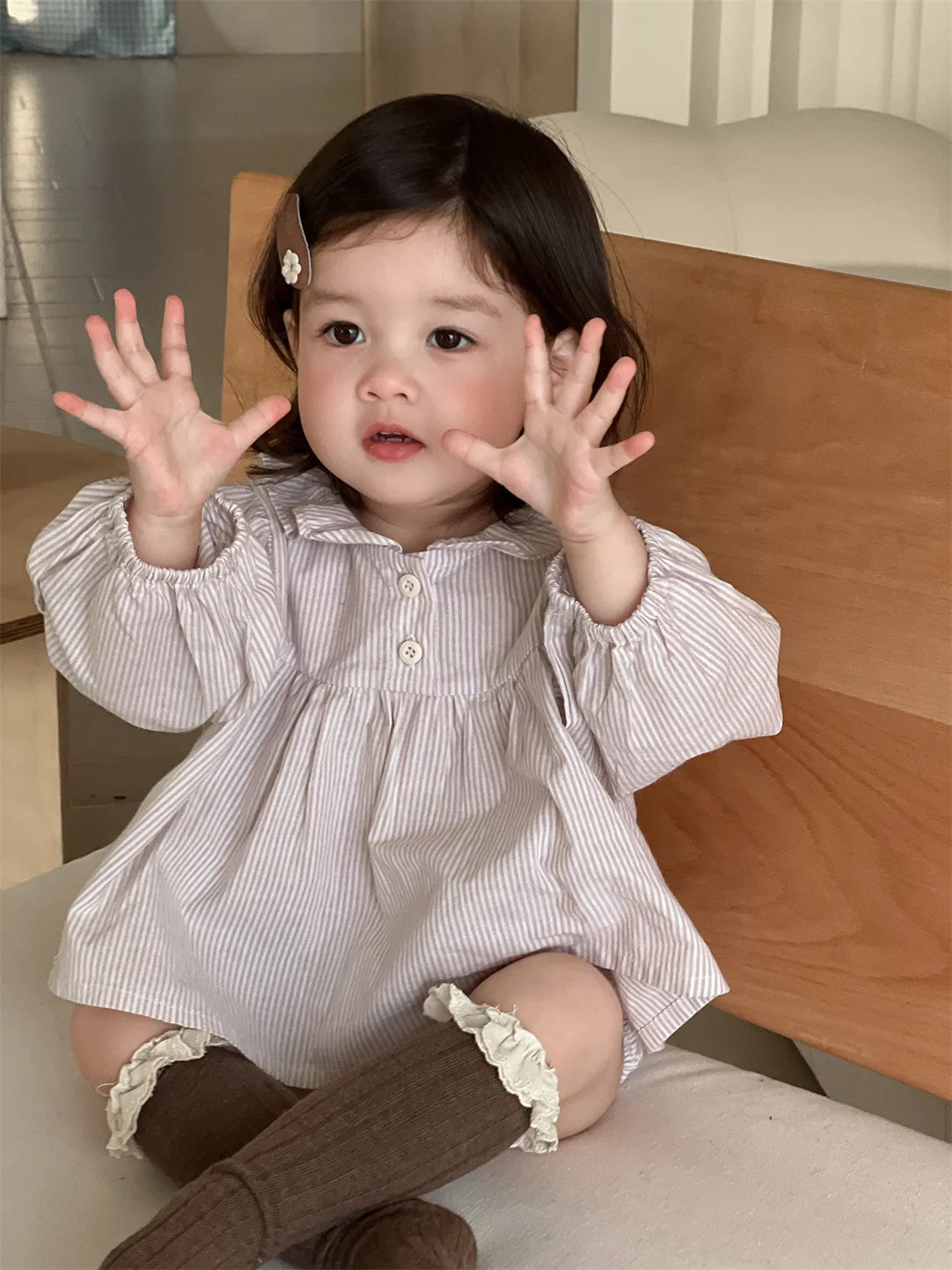 Baby girl wearing Baby Girl Loose Striped Set with long puff sleeves and knee-high brown socks
