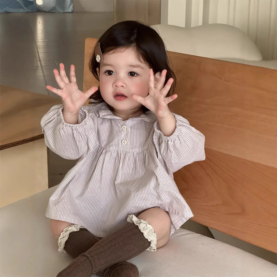 Baby wearing Yamza Tots Closet Baby Girl Loose Striped Set with long sleeves and brown knee-high socks