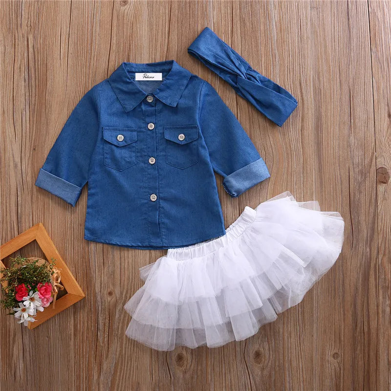 Baby Girls 3 Piece Outfit Set Denim Shirt Tutu Skirt and Headband Clothing laid out on wooden background