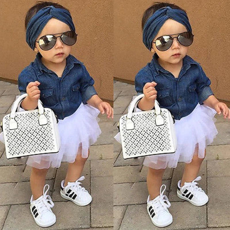 Baby wearing Baby Girls 3 Piece Outfit Set Denim Shirt Tutu Skirt and Headband Clothing with white sneakers and sunglasses