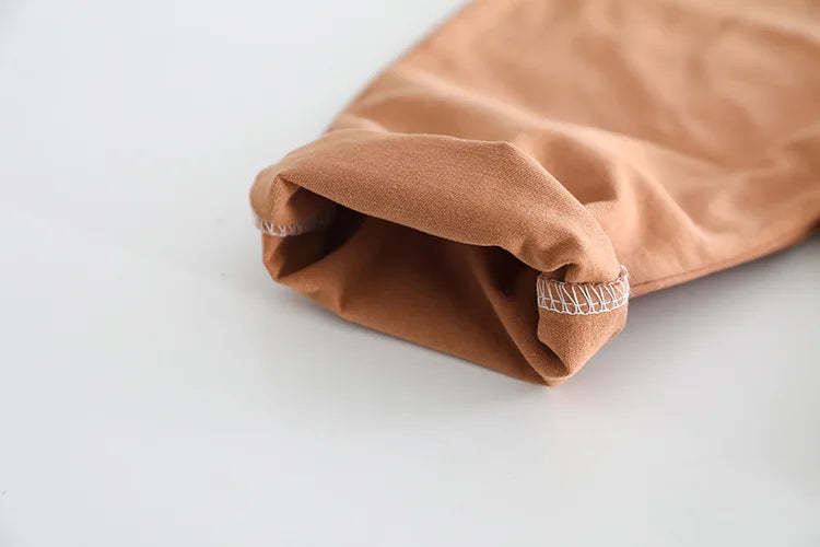 Close-up of soft brown fabric cuff detail from baby girls and boys clothing by Yamza Tots' Closet