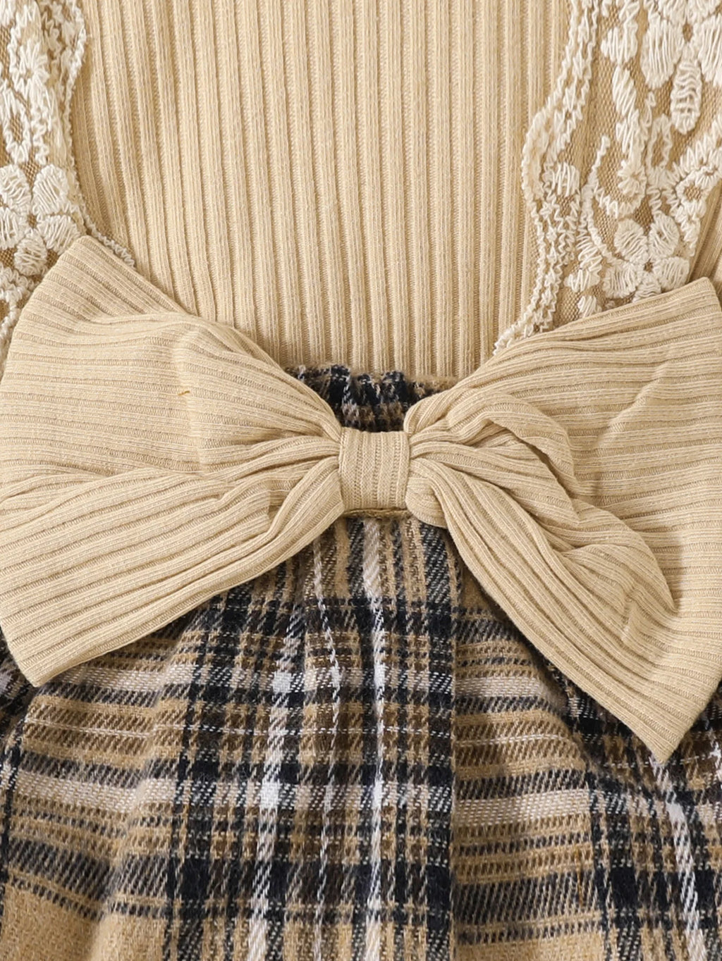 Close-up of Baby Girls Long Sleeve Plaid With Bow featuring beige ribbed bow and brown plaid skirt detailing