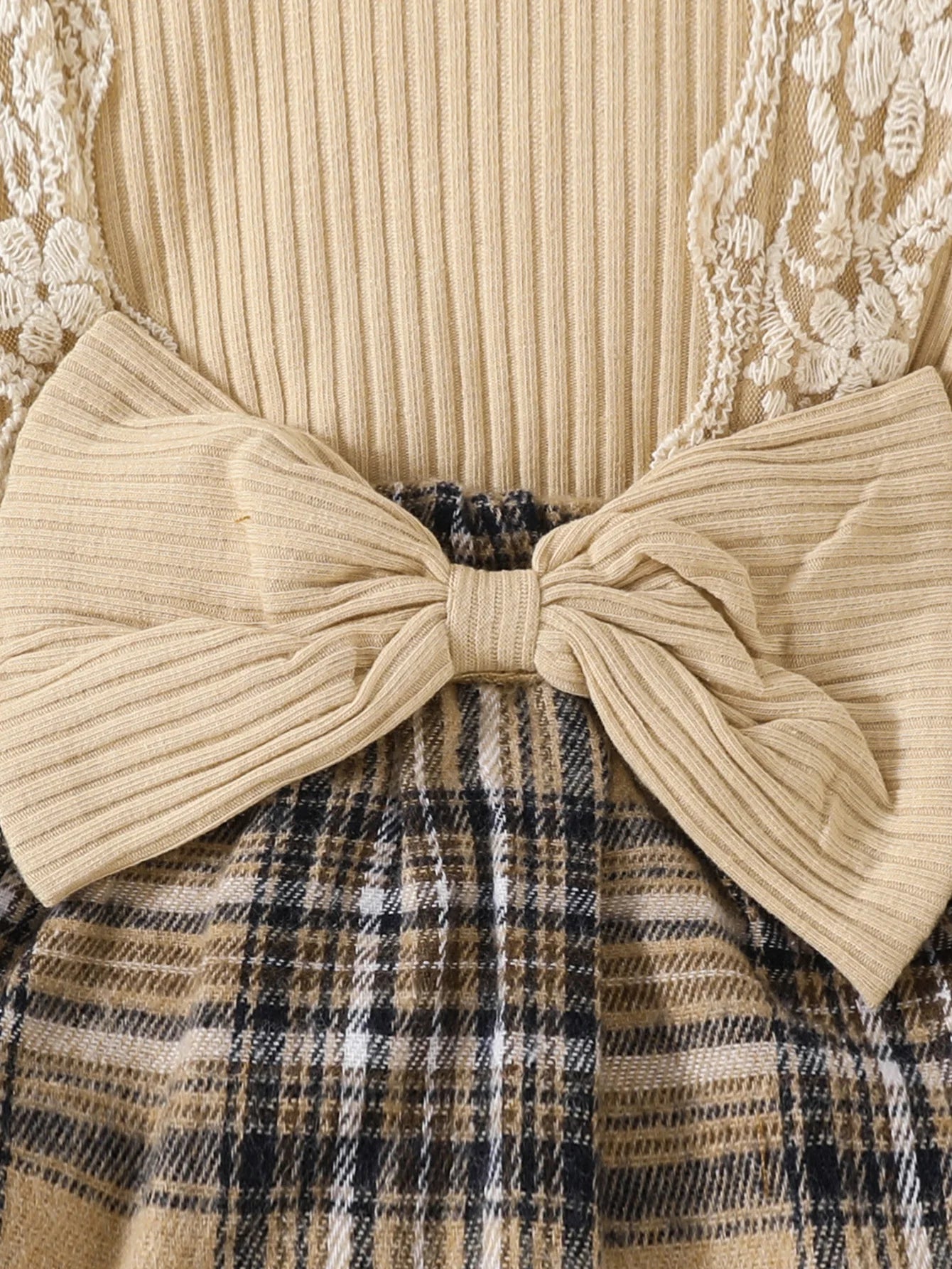 Close-up of Baby Girls Long Sleeve Plaid With Bow featuring beige ribbed bow and brown plaid skirt detailing