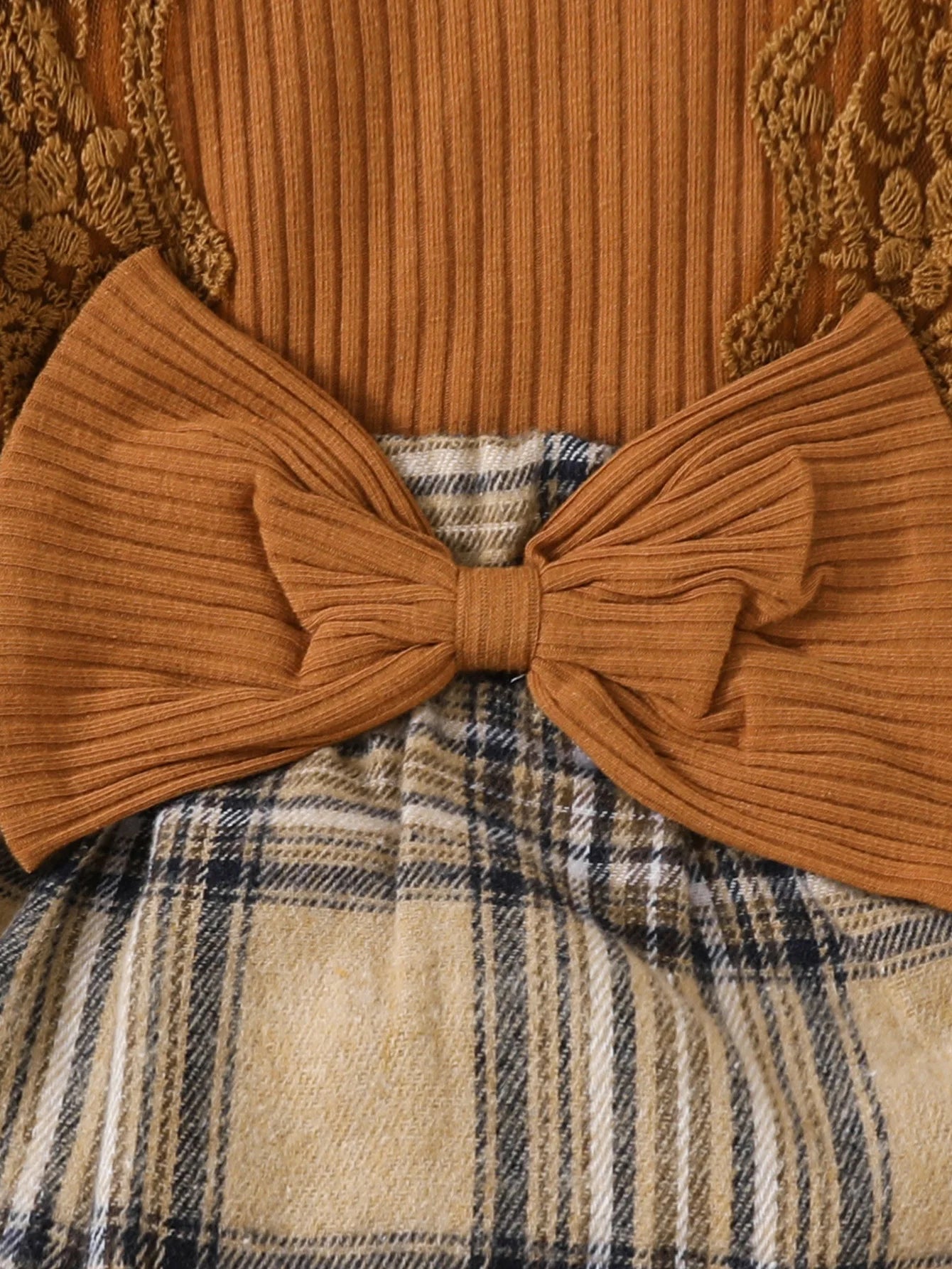 Close-up of Baby Girls Long Sleeve Plaid With Bow dress featuring brown ribbed fabric and plaid skirt