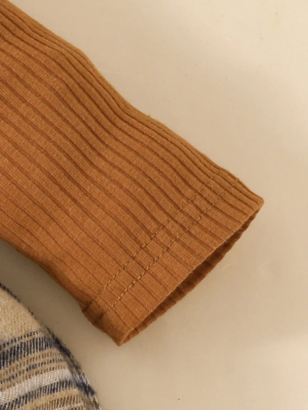 Close-up of ribbed brown sleeve detail on Baby Girls Long Sleeve Plaid With Bow outfit by Yamza Tots' Closet