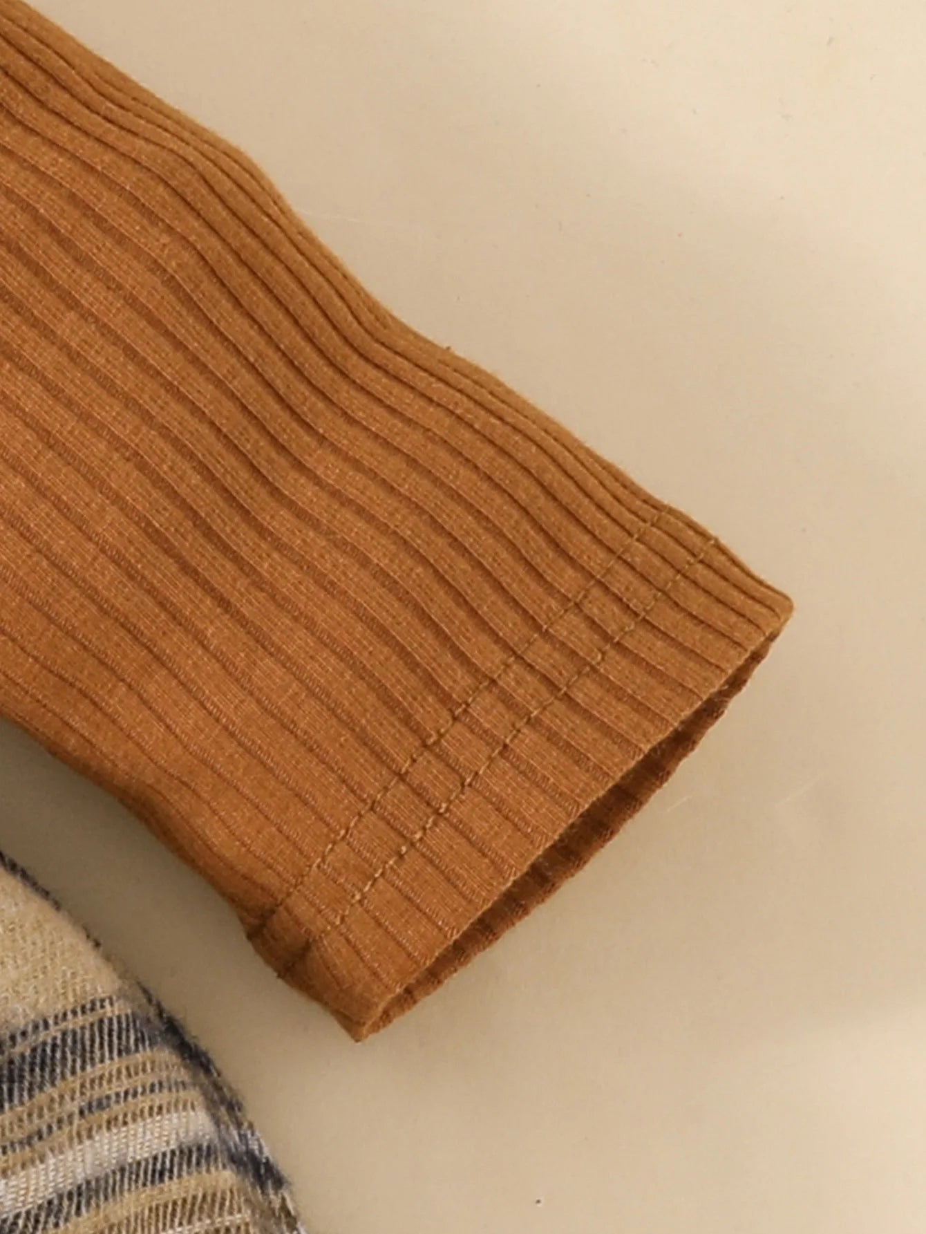 Close-up of ribbed brown sleeve detail on Baby Girls Long Sleeve Plaid With Bow outfit by Yamza Tots' Closet