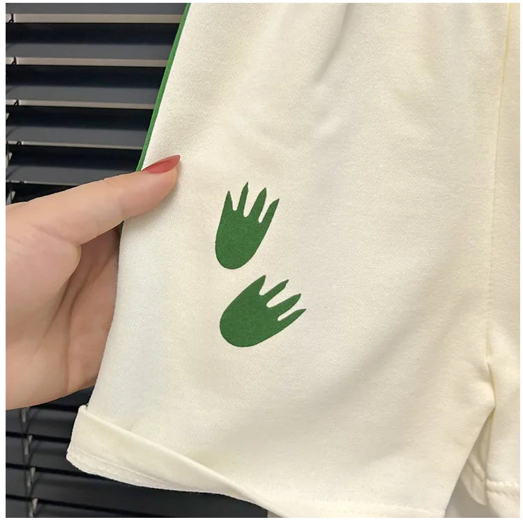 Close-up of white shorts with green leaf print from Baby Striped Short Sleeve T-shirt Set Summer Loungewear for Boys Girls
