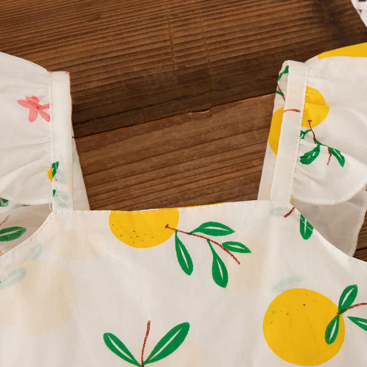 Close-up of Yamza Tots' Closet Beach Dress Casual Fruit Printed with Hat Suit showing yellow fruit pattern and ruffled straps