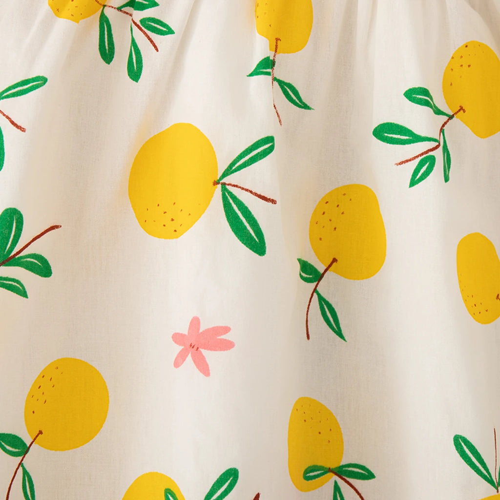 Close-up of Beach Dress Casual Fruit Printed with Hat Suit featuring yellow fruit and green leaves on white fabric