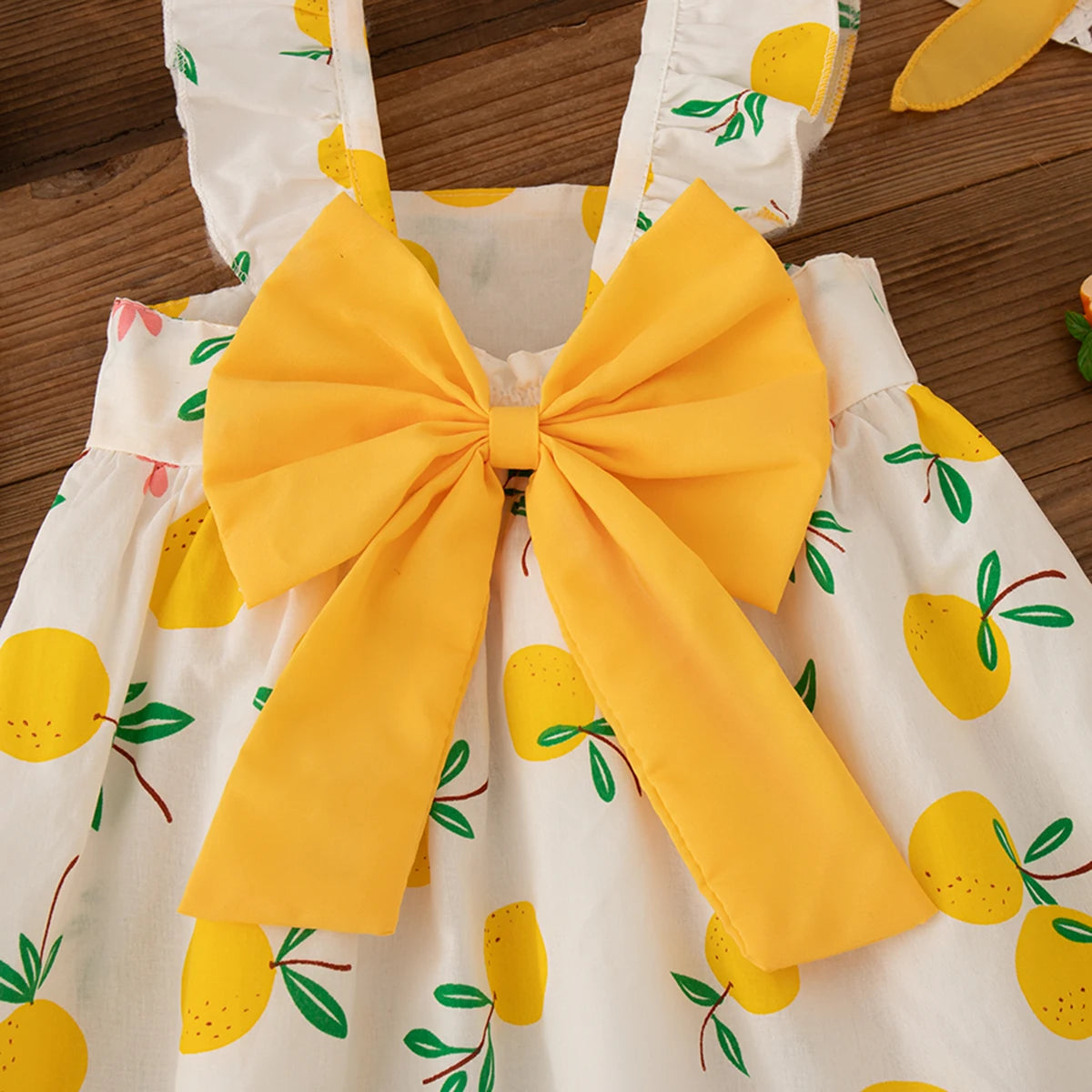 Close-up of yellow bow on Beach Dress Casual Fruit Printed with Hat Suit from Yamza Tots' Closet