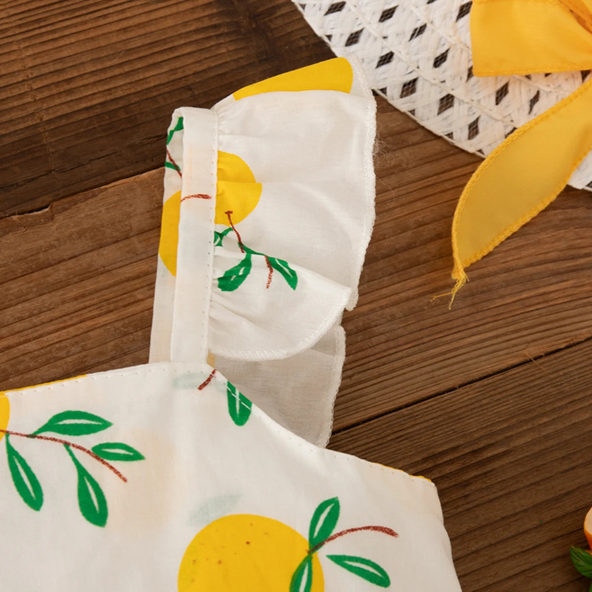 Close-up of Beach Dress Casual Fruit Printed with Hat Suit showing yellow fruit pattern and ruffled straps