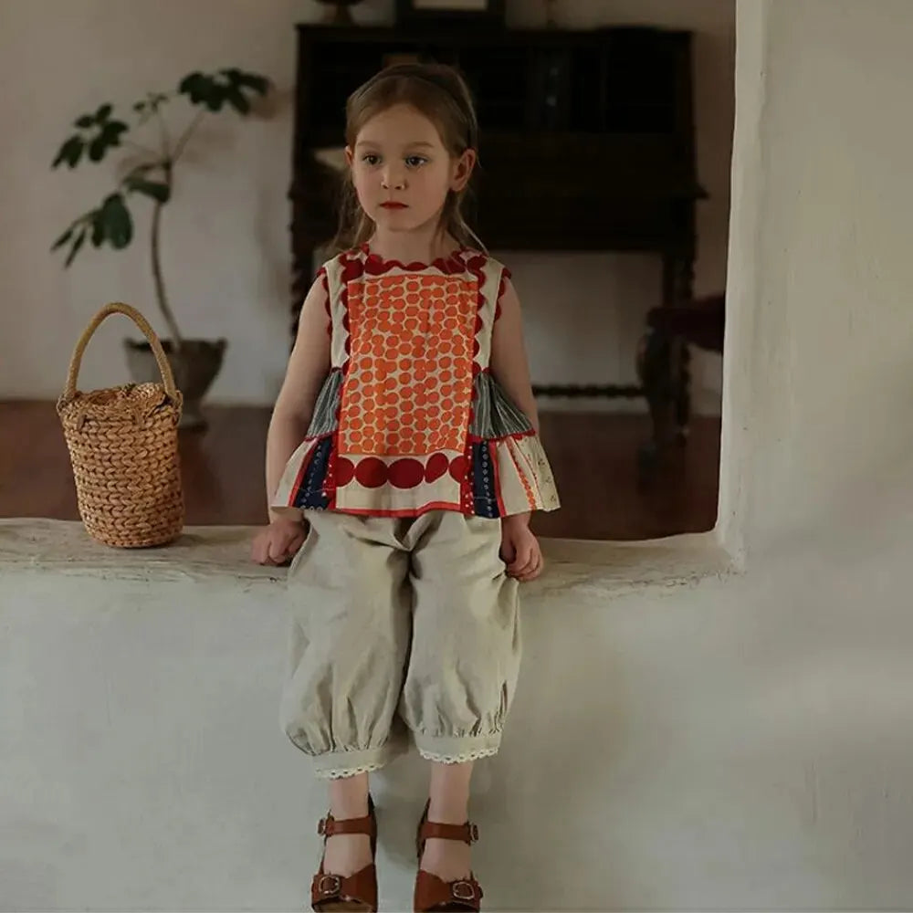 Bear Leader Girls Summer Dress Round Neck Sleeveless Multicolor Geometric Dress worn by a young girl sitting indoors