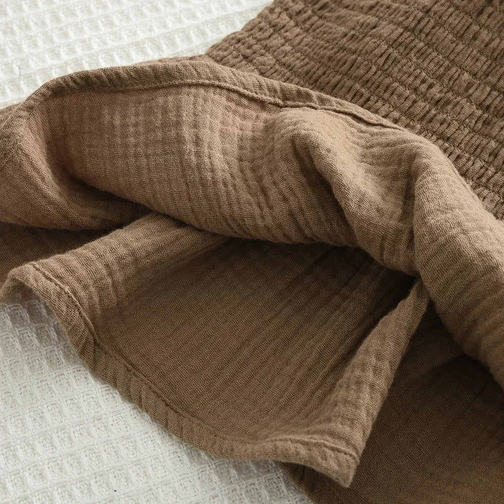 Close-up of brown fabric texture from Korean Kids Summer Organic Cotton Girls Camisole Top with Lace Wide Leg Pants