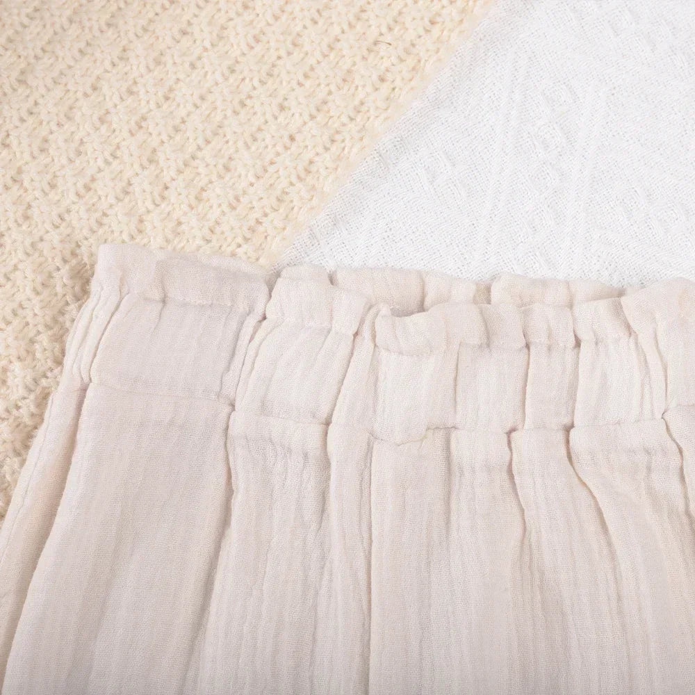 Close-up of beige Korean Kids Summer Organic Cotton Girls Camisole Top with Lace Wide Leg Pants fabric texture