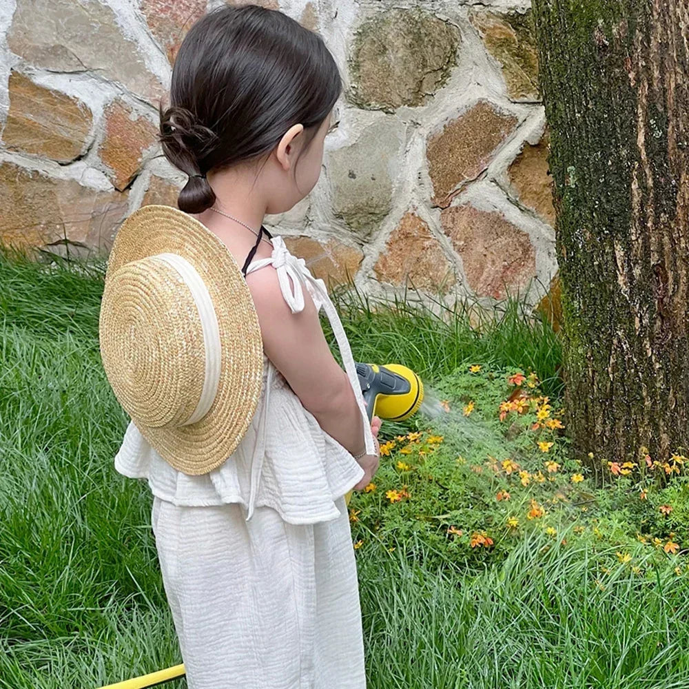 Young girl wearing Korean Kids Summer Organic Cotton Girls Camisole Top with Lace Wide Leg Pants outdoors in garden