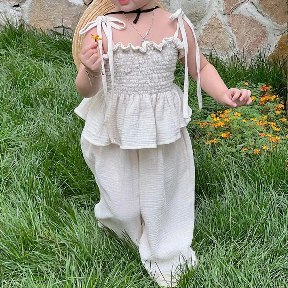 Korean Kids Summer Organic Cotton Girls Camisole Top with Lace Wide Leg Pants worn by child in white outfit outdoors
