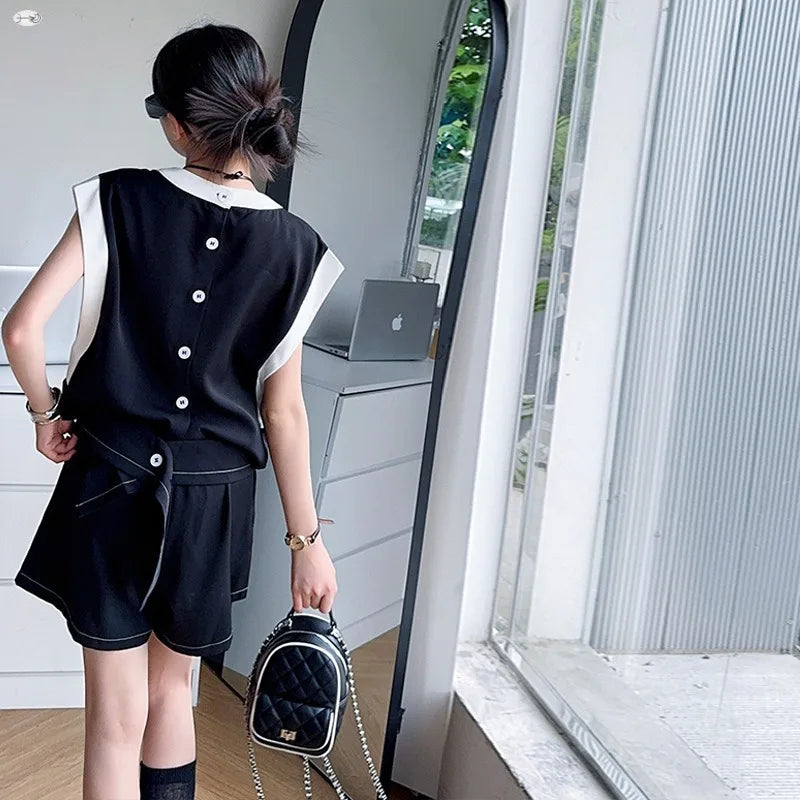 Black and White Spliced Vest and Shorts Two-Piece Casual Sports Outfit Set worn by a child with a small black backpack