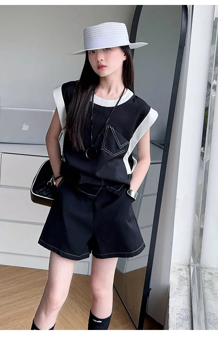 Black and White Spliced Vest and Shorts Two-Piece Casual Sports Outfit Set worn by a girl with a white hat indoors