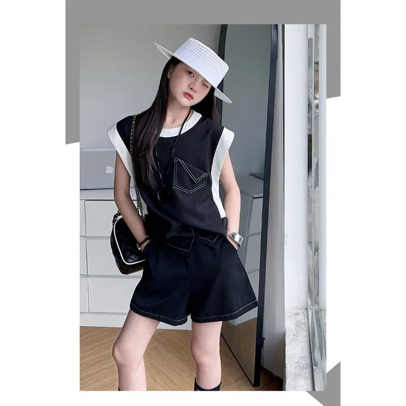 Black and White Spliced Vest and Shorts Two-Piece Casual Sports Outfit Set worn by a model with white hat and black bag